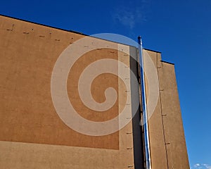 Industrial white building with sheet metal facade of repeating rectangle