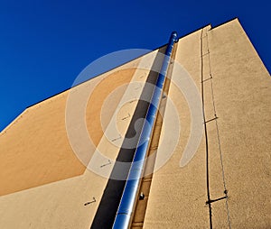 Industrial white building with sheet metal facade of repeating rectangle