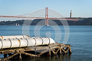 Industrial white pipes feeding into the tagus river, Lisbon, Portugal