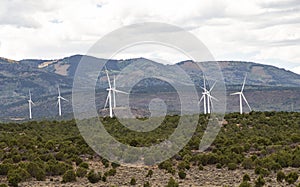 Industrial windmills create a wind farm in the landscape.