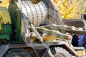 Industrial wood chipper in action