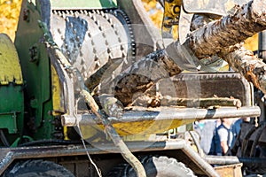 Industrial wood chipper in action