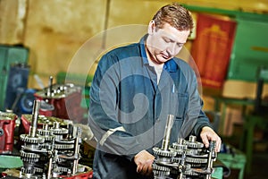 Industrial worker assembling the reduction gear box