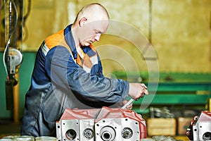 Industrial worker assembling the reduction gear box