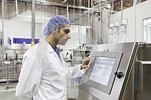 Industrial worker at bottling machine