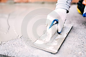 Industrial worker on construction site laying sealant for waterproofing cement