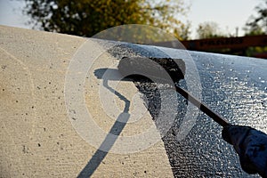 Industrial worker on construction site laying sealant photo