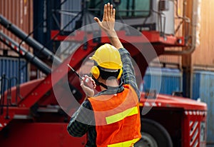 Industrial worker is controlling container loading in import-export business