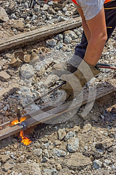 Industrial worker cutting a old tram tracks with an oxy-acetylene torch photo