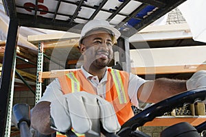 Industrial Worker Driving Forklift At Workplace photo