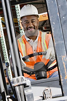 Industrial Worker Driving Forklift At Workplace