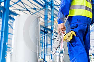 Industrial worker in factory with tools