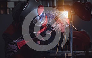 Industrial Worker laborer at the factory welding steel structure