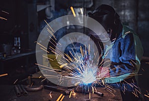 Industrial Worker laborer at the factory welding steel structure