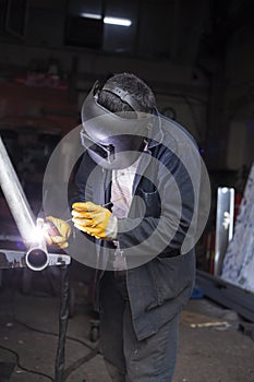 Industrial Worker labourer at the factory welding steel structure