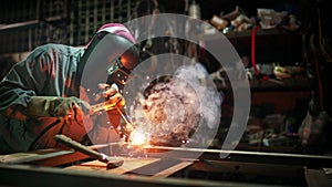 Industrial Worker labourer at the factory welding steel structure