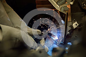 Industrial Worker labourer at the factory welding steel structure