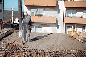 Industrial worker laying concrete with automatic tube pump