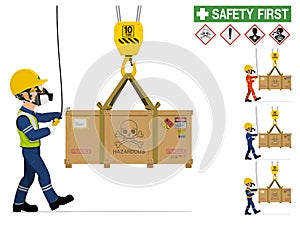 An industrial worker is moving hazardous material by crane