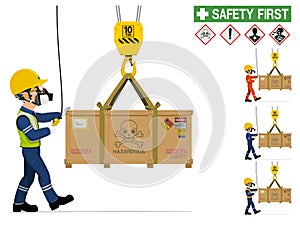 An industrial worker is moving hazardous material by crane photo