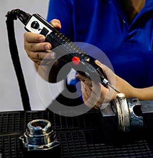 Industrial worker operate Electro-Spark laser overlay / coating device