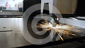 An industrial worker paints metal on a factory production line. A craftsman paints metal doors in production.