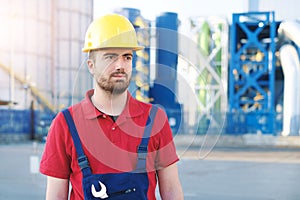 Industrial worker portrait on factory structure background