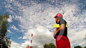 Industrial Worker and Red Factory Chimney Zoom In