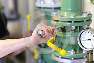 Industrial worker repairs machines and equipment in a refinery