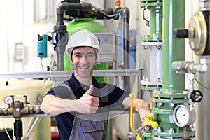 Industrial worker repairs machines and equipment in a refinery