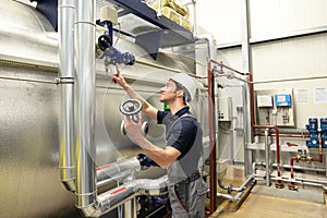 industrial worker repairs machines and equipment in a refinery