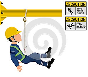 An industrial worker with safety harness is working at height