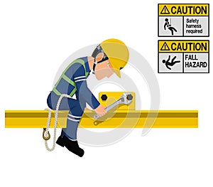 An industrial worker with safety harness is working at height photo