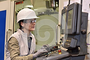 Industrial worker setting up machine in metallurgic industry