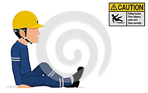 An industrial worker is sitting on the floor