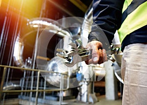 Industrial worker with spanner at factory workshop