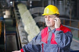 Industrial worker talking on cell phone
