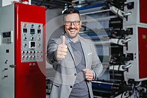 Industrial worker thumb up in factory.   Man in Industrial Environment.