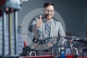 Industrial worker thumb up in factory.   Man in Industrial Environment.