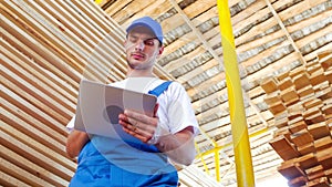 Industrial worker in uniform checking wooden box