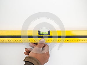 Industrial worker use building level to check balance edge of wall to checking level of wall at construction