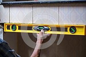 Industrial worker use building level to check balance edge of wall to checking level of wall at construction