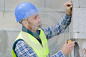 Industrial worker uses meter outdoors