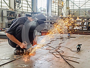 Industrial worker using angle grinder