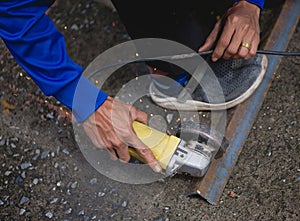 Industrial Worker Using Angle Grinder and Cutting a Metal