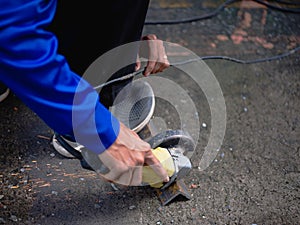Industrial Worker Using Angle Grinder and Cutting a Metal