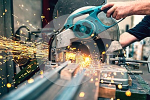 Industrial worker using a compound mitre saw with sharp blade