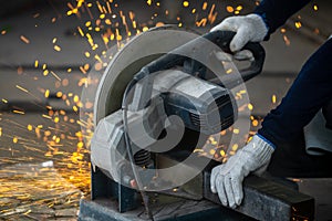 Industrial worker using electric grinder cutting metal, Electric grinder cutting metal bright sparks, Metal grinder cut iron pipe