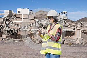 Industrial worker using tablet on construction site photo