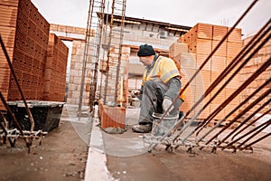 Industrial worker using trowel and tools for building exterior walls